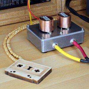 Stereo Hi-Fi audio transformer box with copper shield on studio table.