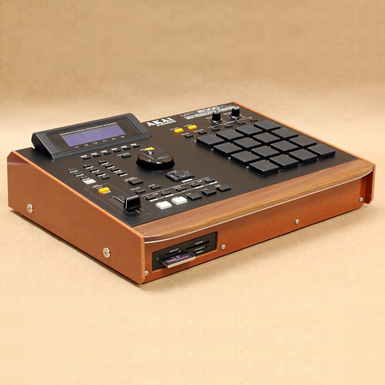 Custom modular Akai MPC 2000XL with brown Phenolic bezel, hardwood wrist rest and hot swap card reader, on craft paper background.